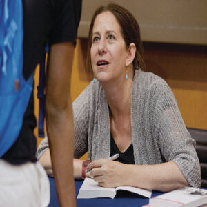 This image features American journalist and author Barbara Demick signing books. 